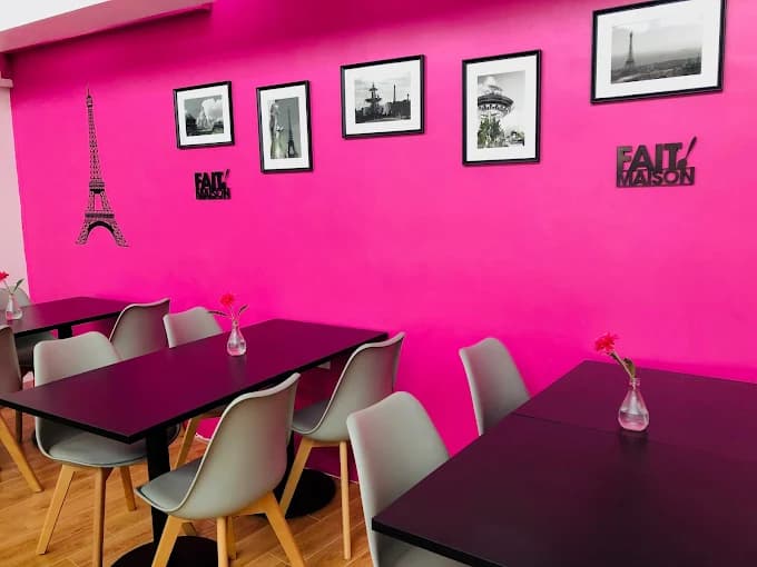 Pause Café's charming interior with French decor and galette preparation